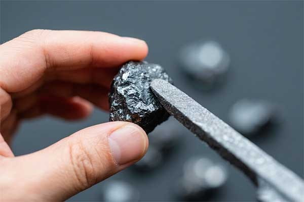 5. rubbing lodestone with iron to make magnets-min.webp